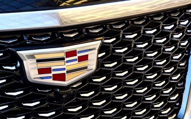 Close-up of the Cadillac emblem on a black mesh front grille