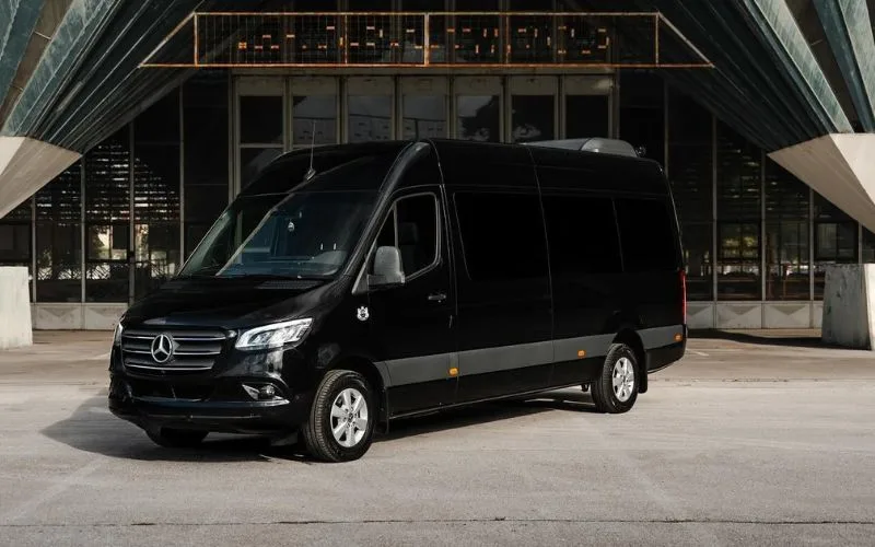 Detailed view of a Sprinter Limo bar area with glassware and integrated entertainment control systems