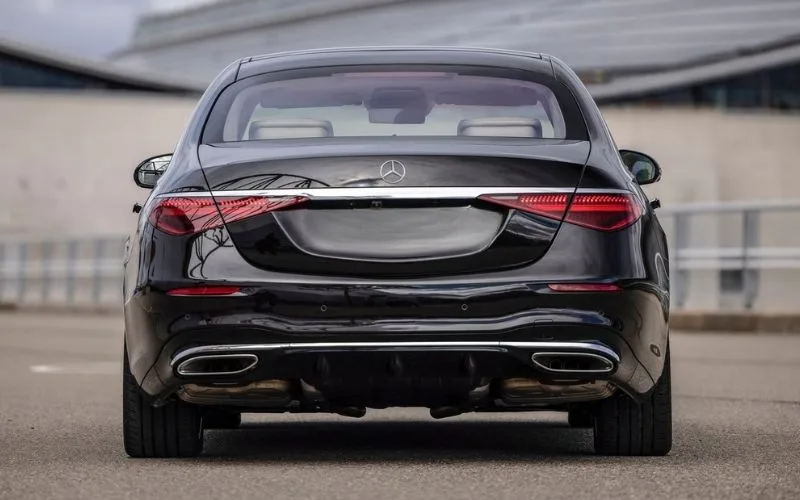 Rear view of a black Mercedes-Benz S-Class showing the sleek taillight design and dual exhaust