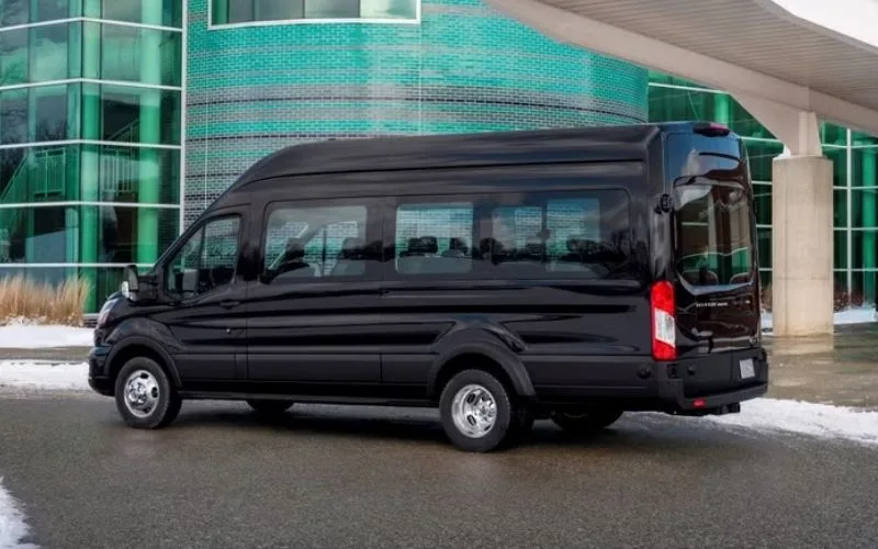 Side profile of a black Ford Transit Van (14 PAX) used for group executive airport transfers