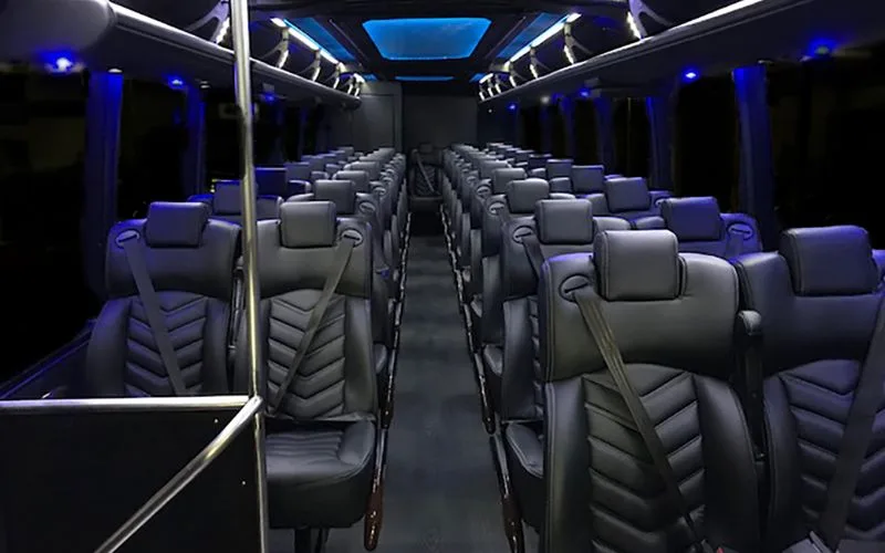 Side view of a luxury 40-passenger Motor Coach featuring tinted windows and a sleek black finish