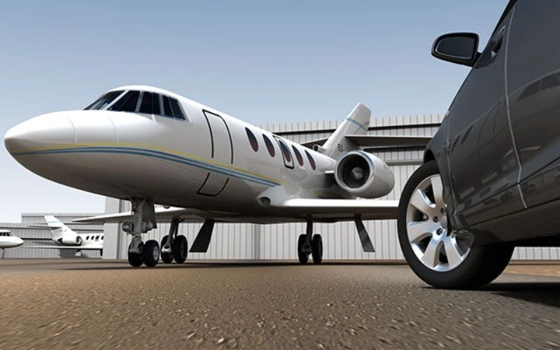 private jet parked next to car at airport private jet parked next to car at airport