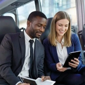Business travelers enjoying a comfortable charter bus ride