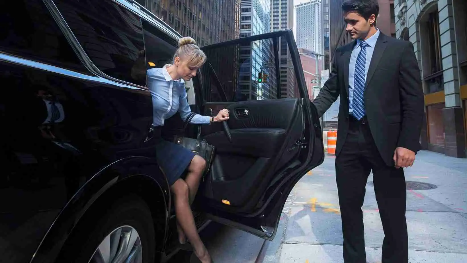 concert-event-transportation-professional-standards Chauffeur helping a passenger into a black car
